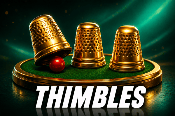 Golden thimbles shell game with red ball under thimble on green felt tray - thimbles gambling game